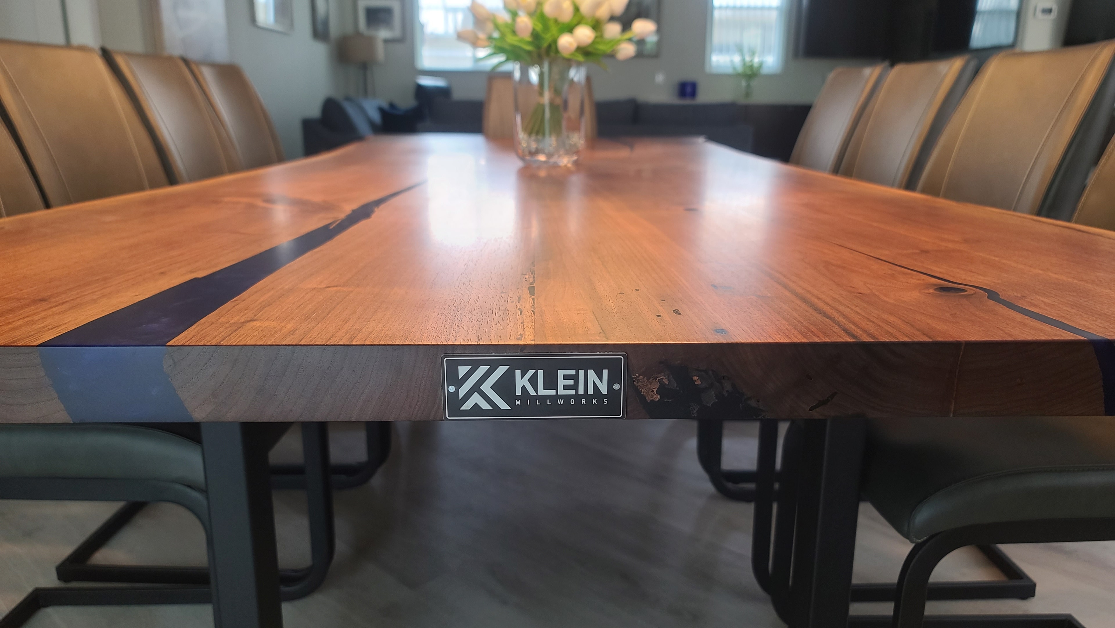 Klein Millworks live-edge epoxy river dining table with branded plate